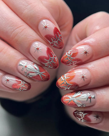 Handmade almond press-on nails with red glitter, silver sword, thorn, and star designs