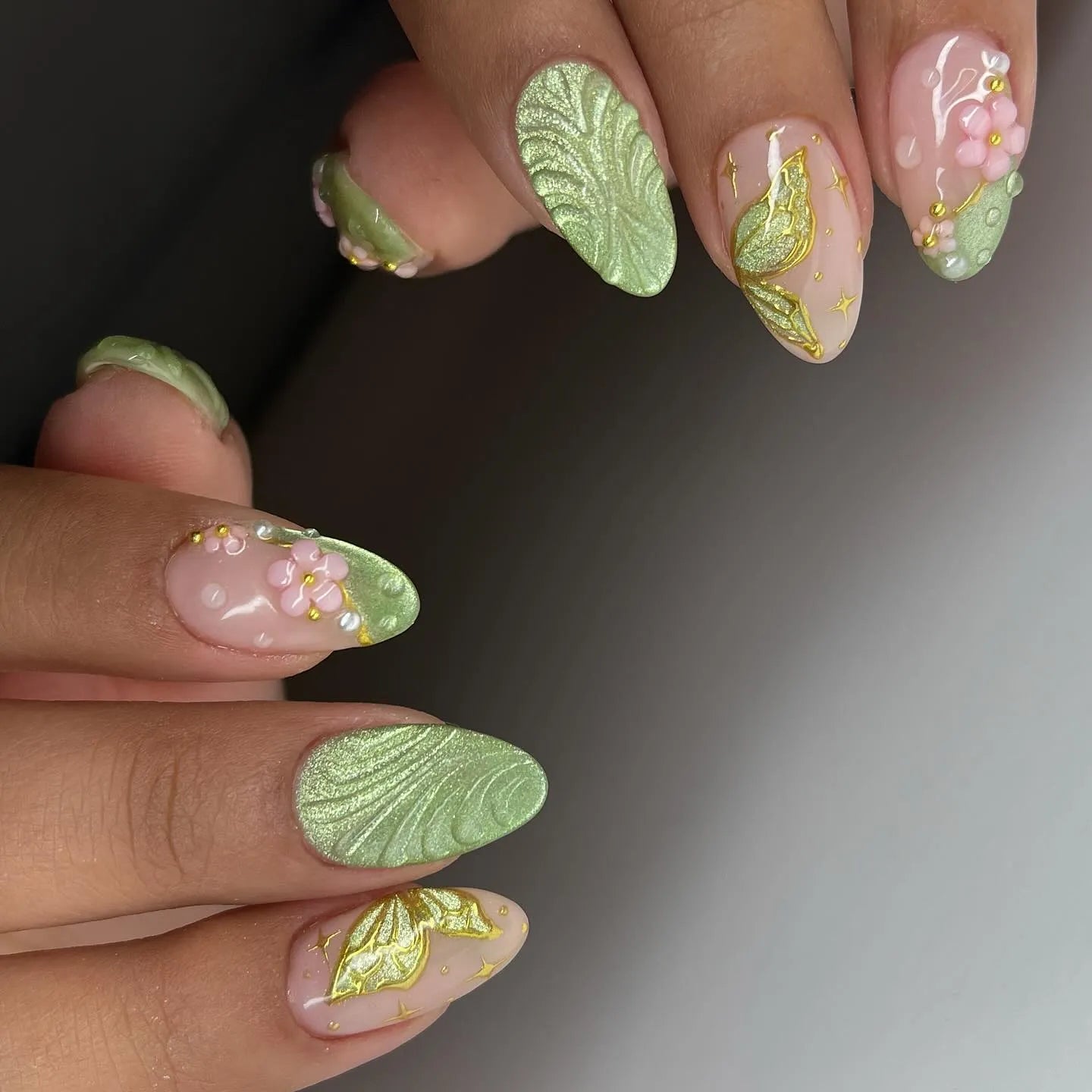 Handmade sage green press-on nails with 3D floral, leaf, and butterfly garden designs.