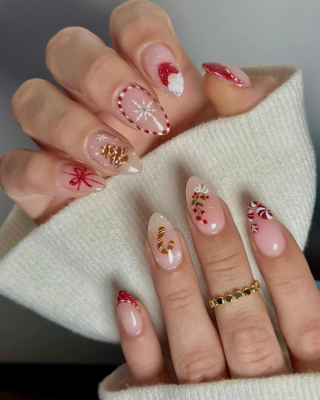 Hand decorated press-on nails with Santa, snowflakes, candy cane, and festive holiday designs.