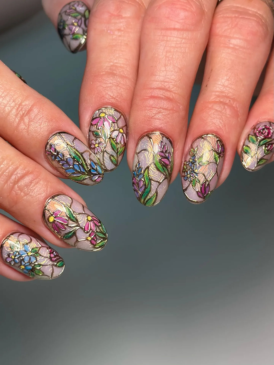 Handmade stained glass floral press-on nails with colorful intricate flower designs