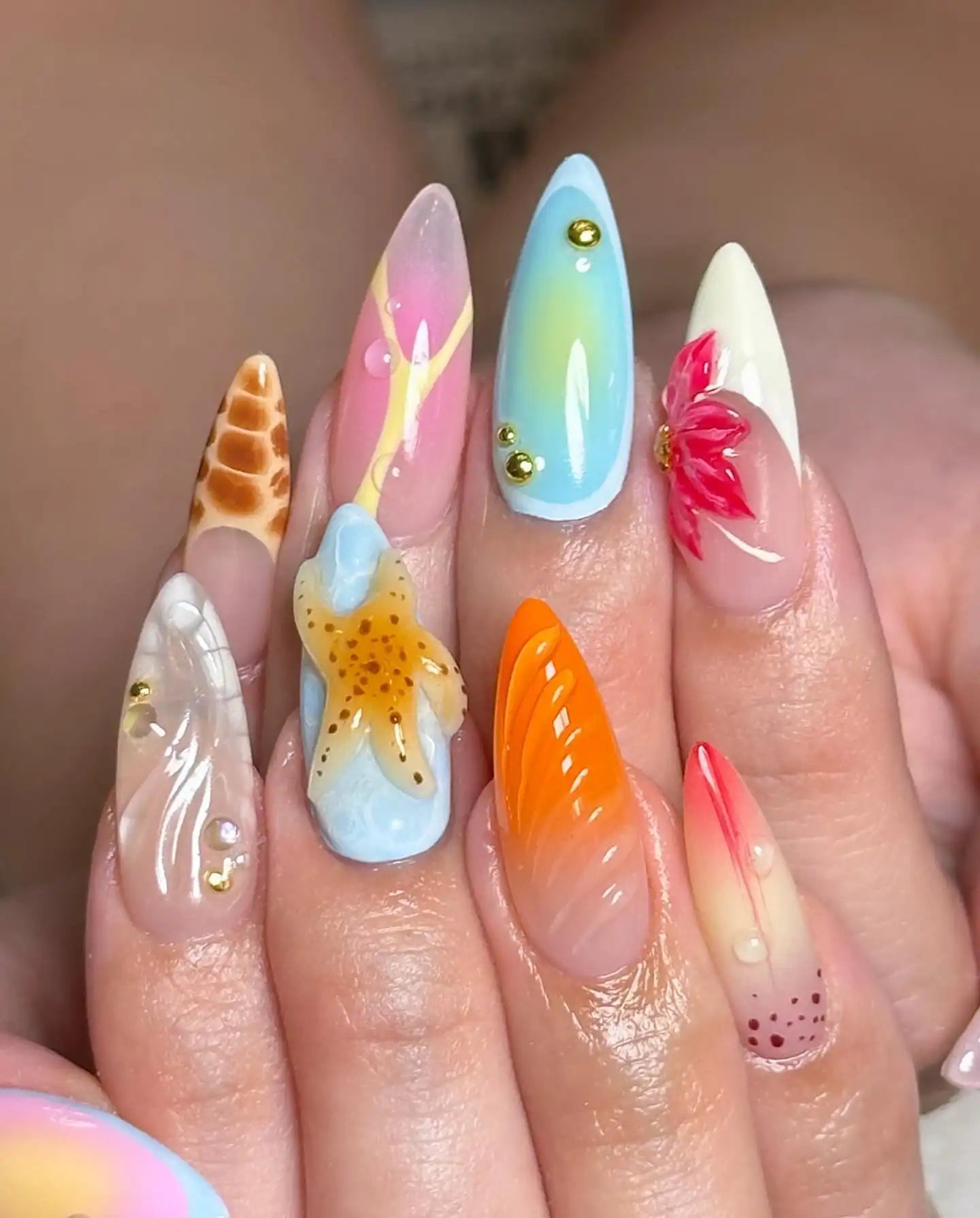 Colorful handmade press-on nails with starfish, seashell, floral, and summer beach designs.
