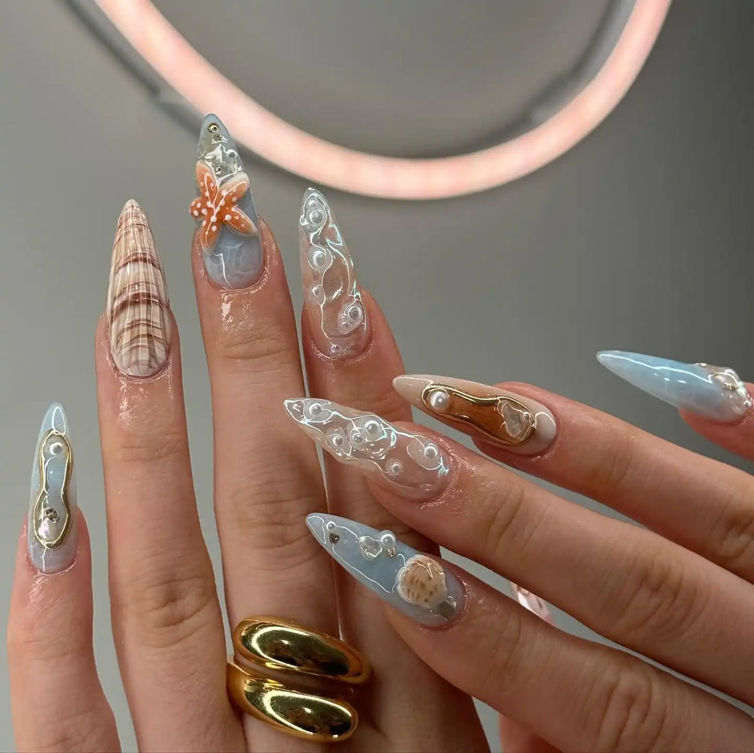 Handmade press-on nails with seashell, starfish, white pearls, and ocean-inspired designs.