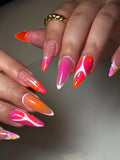 Handmade press-on nails with pink, orange, and white abstract summer gradient design