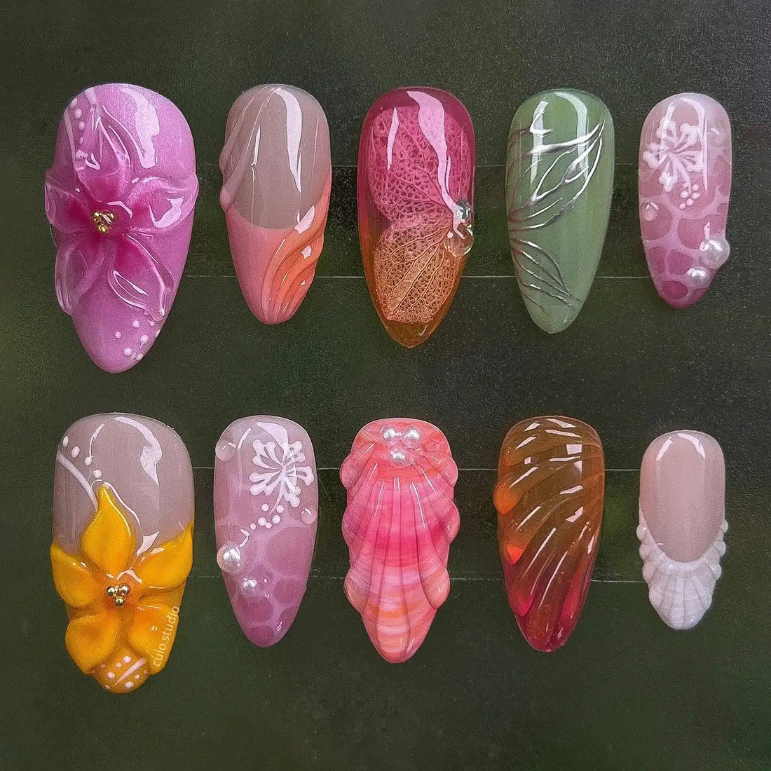 Handmade press-on nails with tropical orchid, leaf, shell, and sunset beach designs