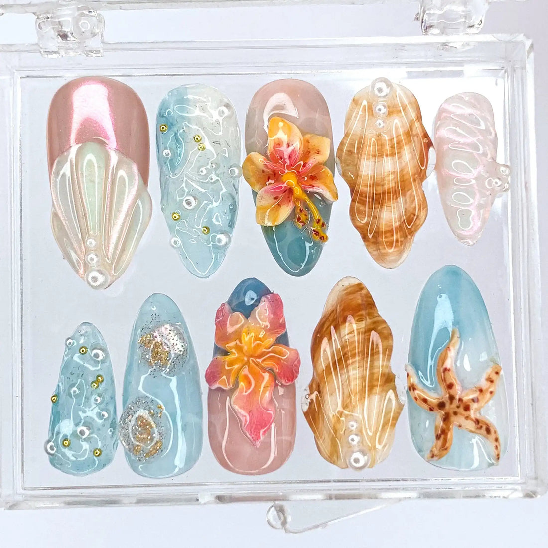 Handmade tropical press-on nails with starfish, seashell, flower accents and glitter ocean design