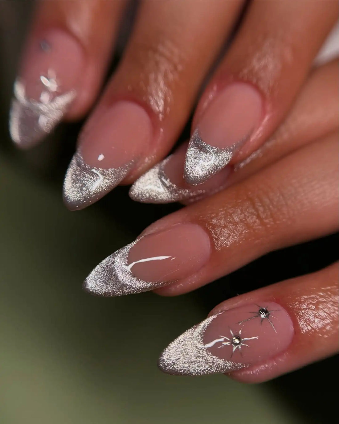 Handmade press-on nails with white cat eye and silver glitter French tips, almond shape