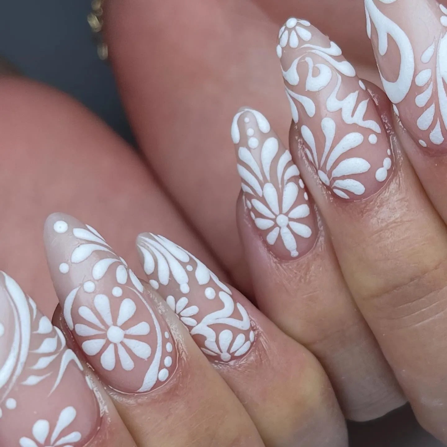 Handmade white lace floral swirl press-on nails with elegant bridal nail art.