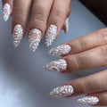 Handmade white lace floral swirl press-on nails with elegant bridal design on almond shape tips