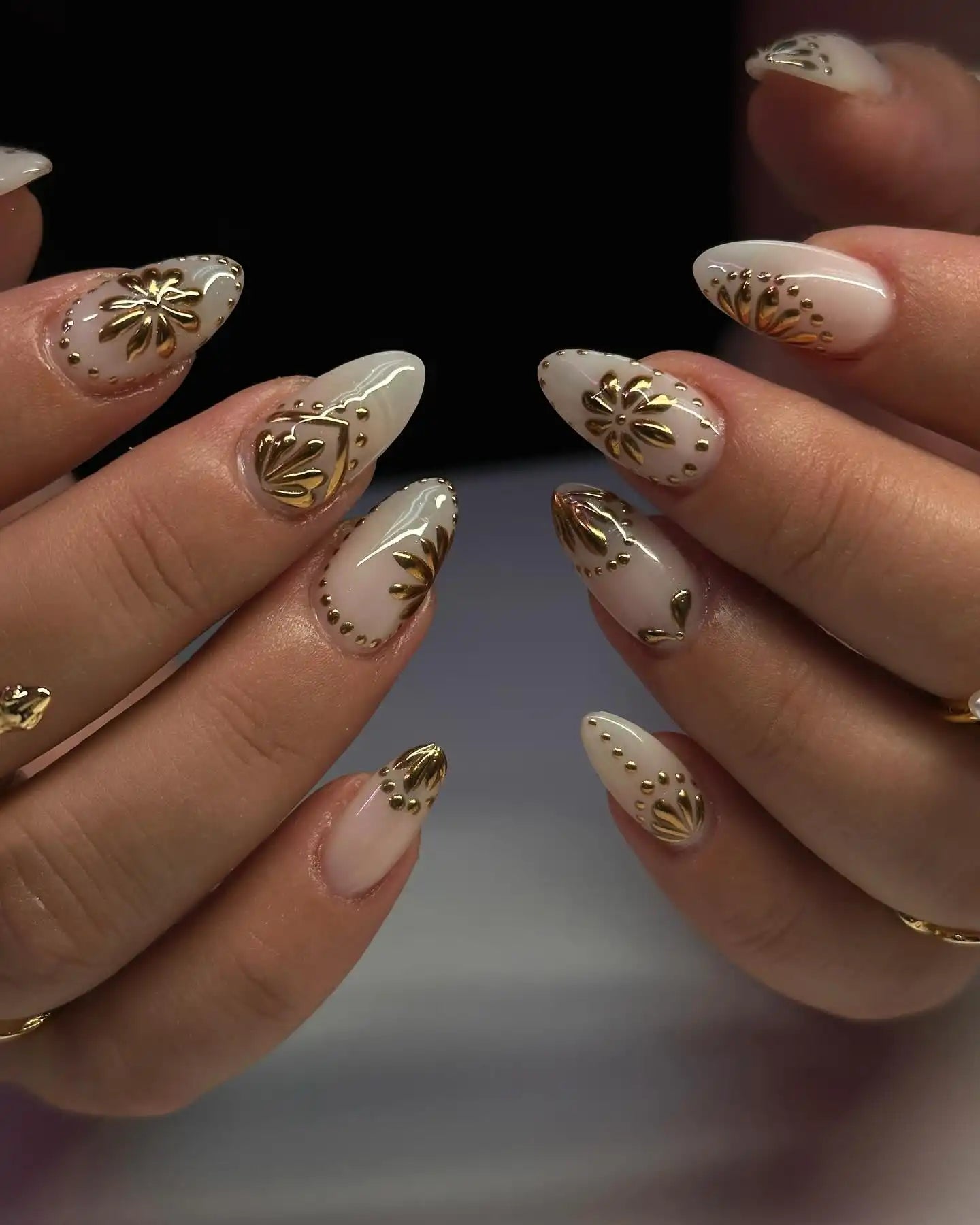 Handmade white and gold 3D floral press-on nails with glossy finish and accent designs