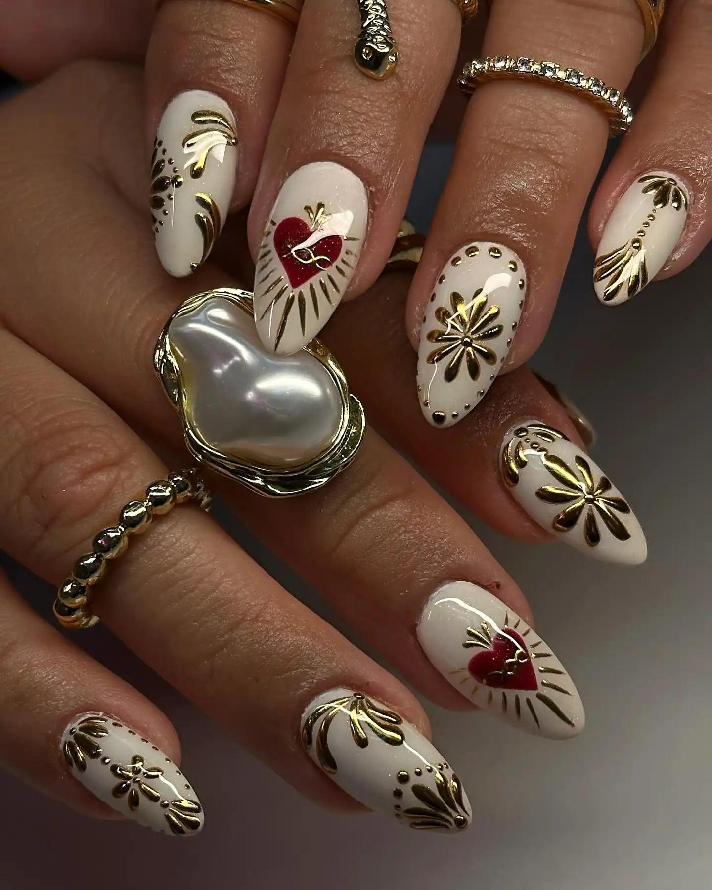 Handmade white press-on nails with gold floral accents and red heart Sacred Heart design