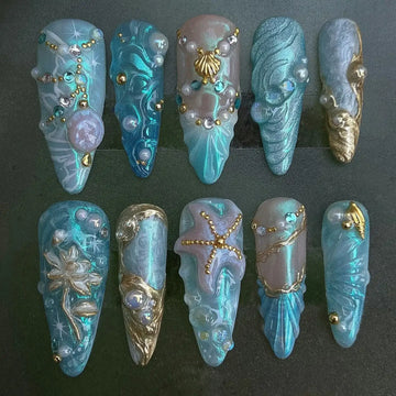 Handmade blue mermaid fantasy press-on nails with starfish, shell, pearl, and gold accents