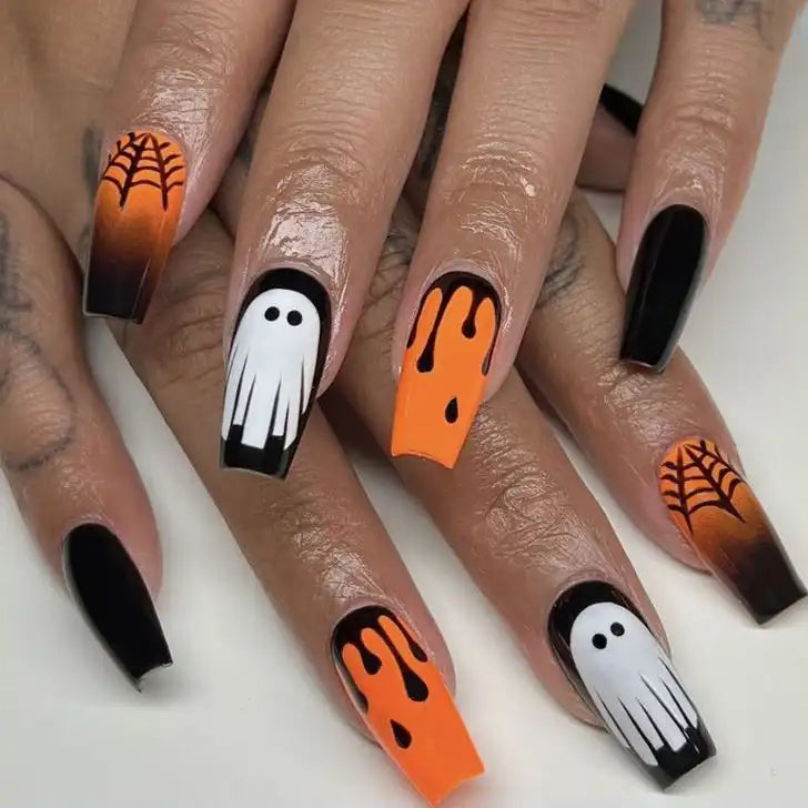 Hand-painted Halloween press-on nails with ghost, spiderweb, and orange drip designs