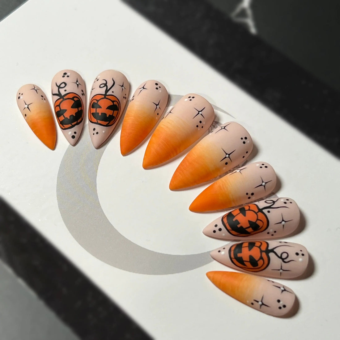 Halloween press-on nails with orange gradient and jack-o'-lantern pumpkin designs