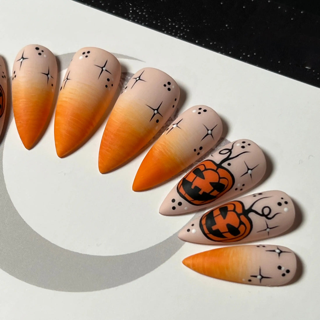 Halloween press-on nails with orange gradient and jack-o'-lantern pumpkin designs