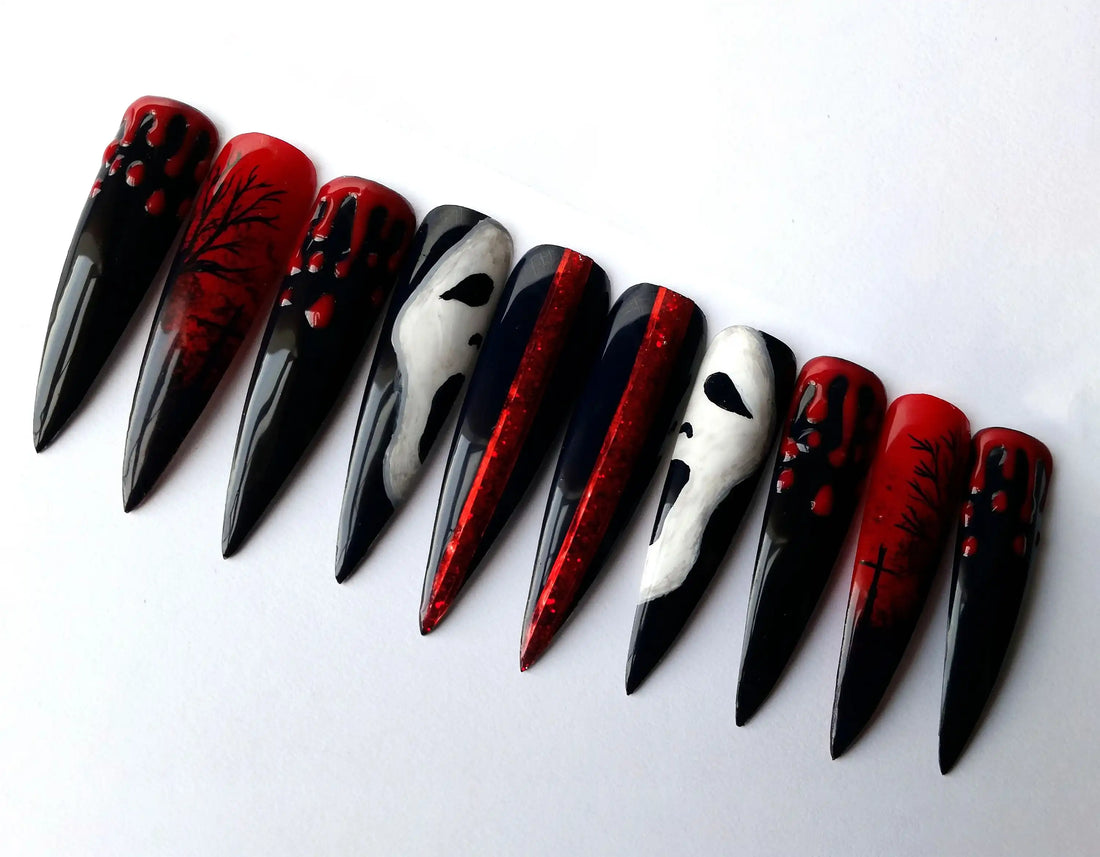 Long stiletto press-on nails with black, red, ghost face, blood drip, and spooky tree designs