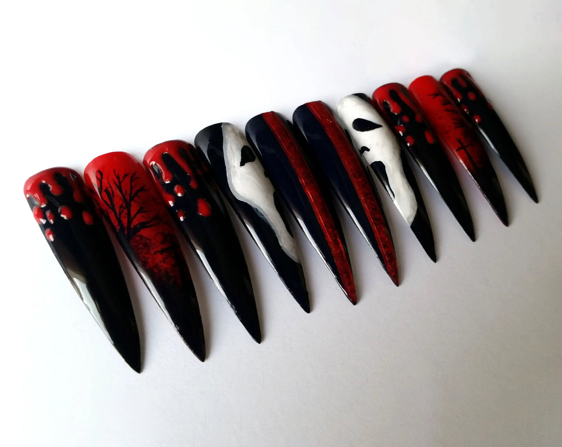 Long stiletto press-on nails with black, red, ghost face, blood drip, and spooky tree designs