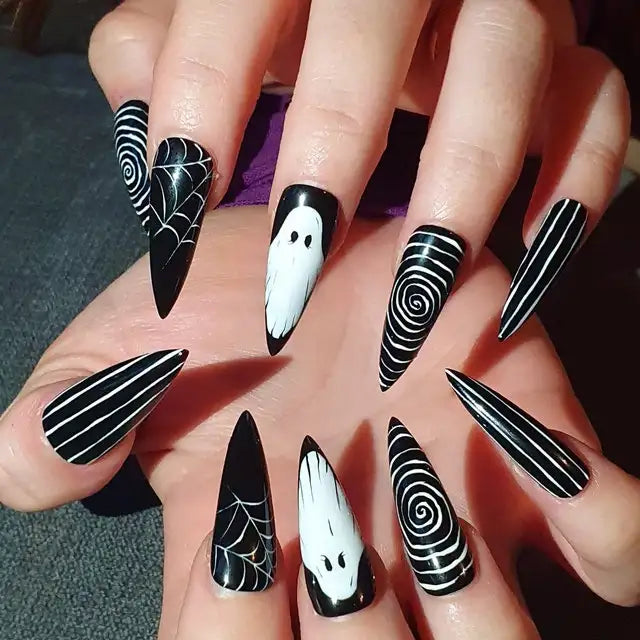 Handmade black press-on nails with white ghost, spiderweb, and swirl Halloween designs