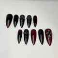 Red and black ombre stiletto press-on nails with gothic cross charms, Halloween nail art
