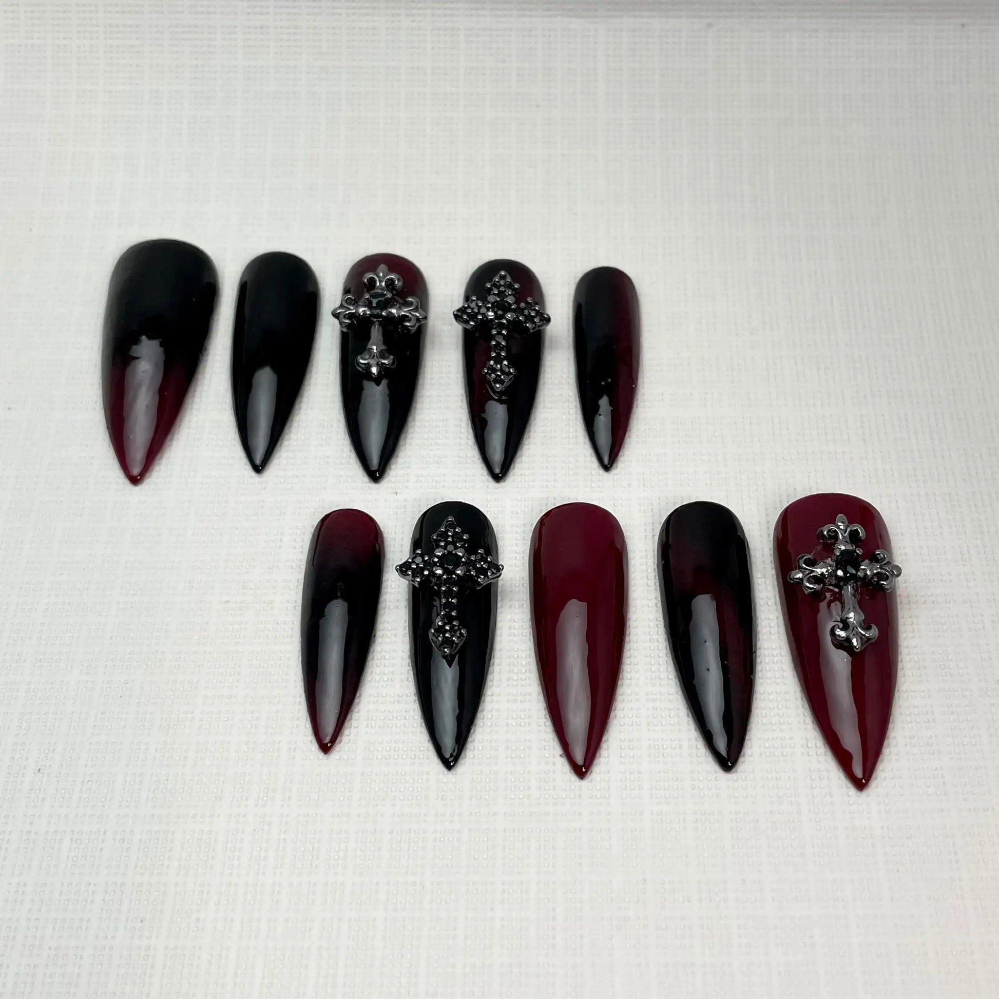 Red and black ombre stiletto press-on nails with gothic cross charms, Halloween nail art