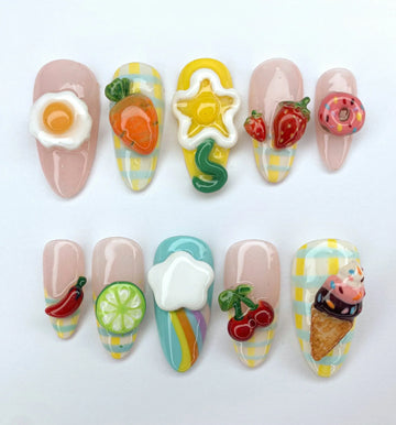 Handmade press-on nails with colorful 3D food and fruit designs, playful reusable nail art